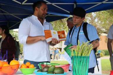 Man showing pamphlet to another man
