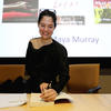 Novelist Yxta Maya Murray signs her book for a guest during a Writers Week on Monday, Feb. 11.