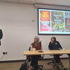 UCR's Jade Sasser, the symposium's organizer speaks at a lectern during a session of research. Seated at a table next to her are Amy Padula, left, of UC San Francisco and Bhavna Shamasunder of UC Santa Barbara.