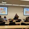 Erin Edwards, executive director of Blue Zones Project Riverside, speaks to symposium attendees seated at tables.
