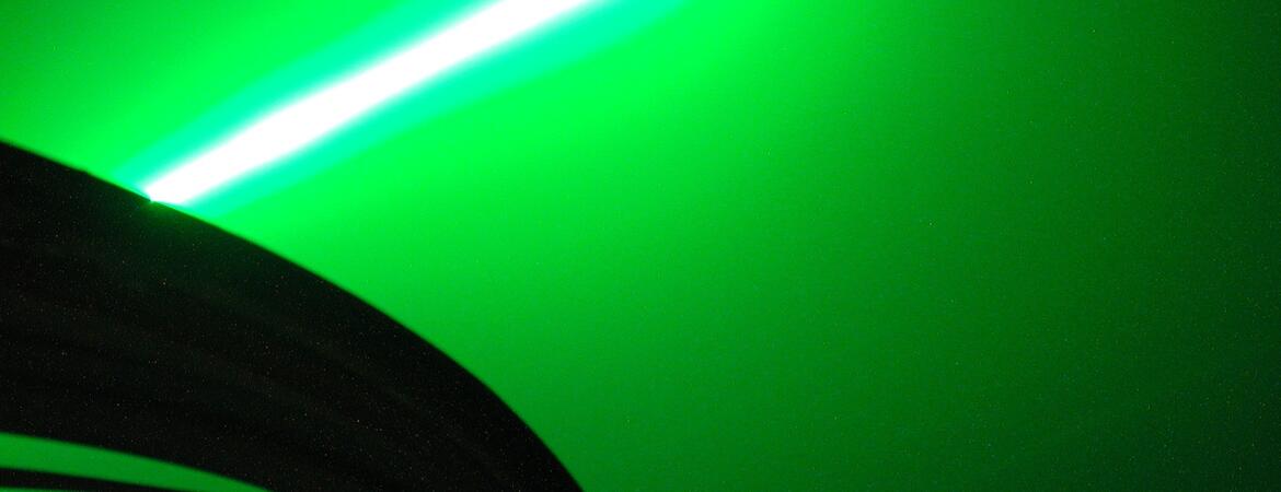 The brilliant green beam of the lidar at the Mauna Loa Observatory (MLO) measures aerosols and water vapor high in the stratosphere. This unretouched image was made when fog briefly formed during an observing session. The camera The camera was leaned against the side of the dome that houses the Dobson spectroradiometer that measures the ozone layer. Hawaii, Mauna Loa.