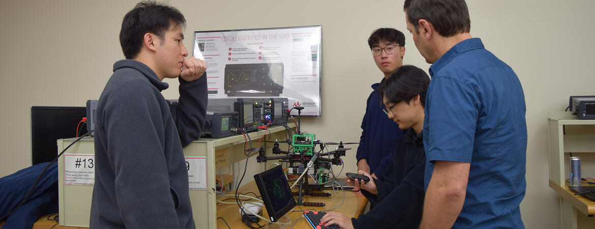 Engineering students work with equipment