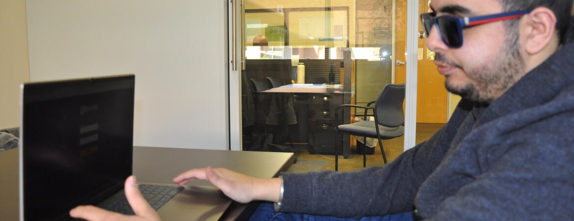 Student Kald Alhomse with laptop