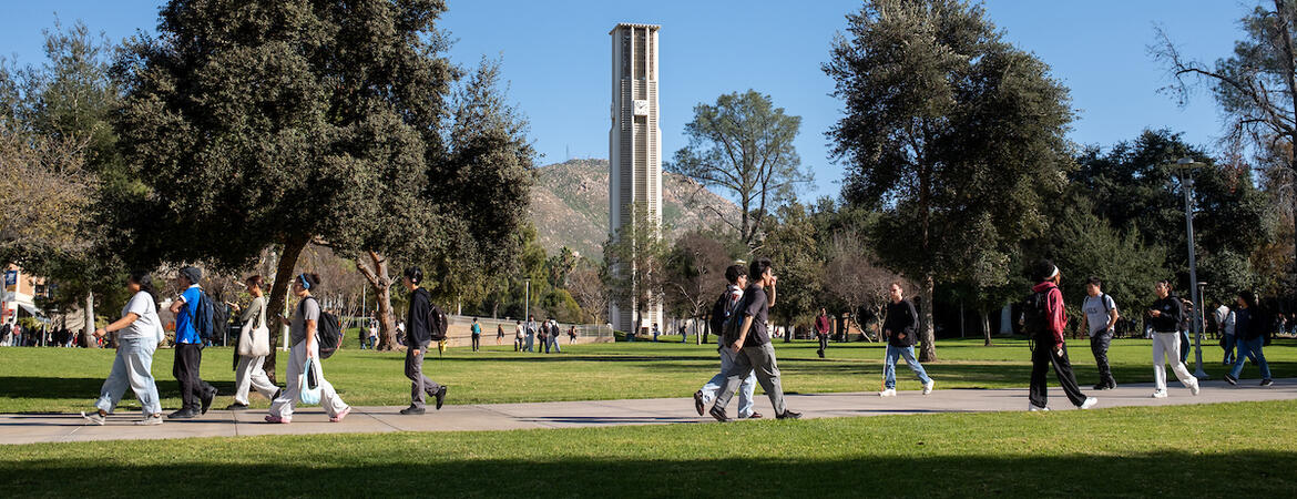 Campus bell tower and lawn with students