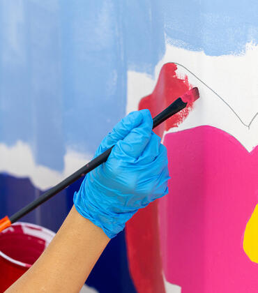 In honor of California Clean Air Day, UCR’s Office of Sustainability, R'Garden, Metrolink, and the City of Riverside hosted a day-long painting event on Tuesday, Oct. 3, 2023 alongside Riverside muralist Ekaterina Orlovie. Students, staff, faculty, and community members painted this “smog-eating” mural using paint with Photio, a paint additive that helps transform surfaces into air purifying agents. (UCR/Stan Lim)