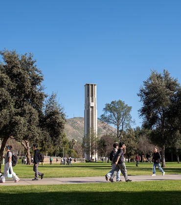 Campus bell tower and lawn with students
