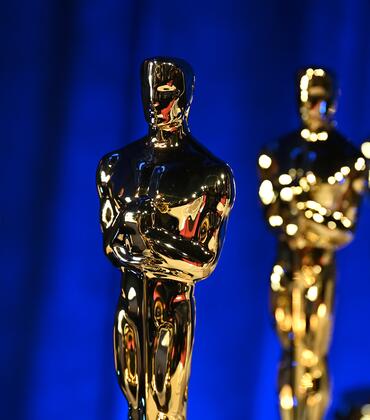 Photo of several Oscar statues in a line.