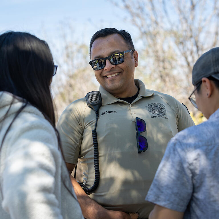 Campus safety responder Oscar Jacques with two students