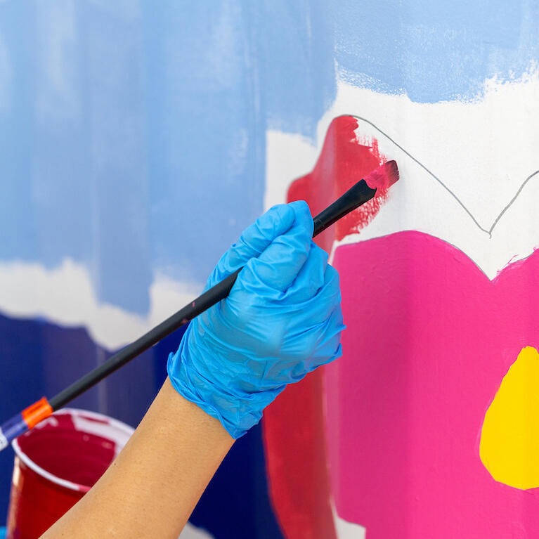 In honor of California Clean Air Day, UCR’s Office of Sustainability, R'Garden, Metrolink, and the City of Riverside hosted a day-long painting event on Tuesday, Oct. 3, 2023 alongside Riverside muralist Ekaterina Orlovie. Students, staff, faculty, and community members painted this “smog-eating” mural using paint with Photio, a paint additive that helps transform surfaces into air purifying agents. (UCR/Stan Lim)