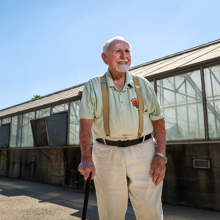 Jerry Ervin in front of greenhouse
