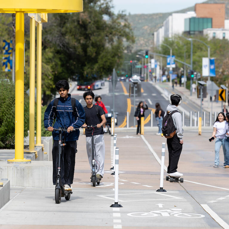 Students on scooters in bike lane