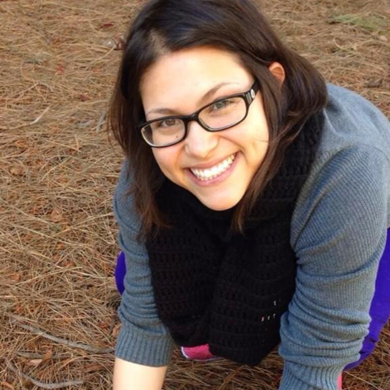 Mycologist Sydney Glassman holding a mushroom