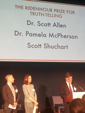 Recipients of prize at podium