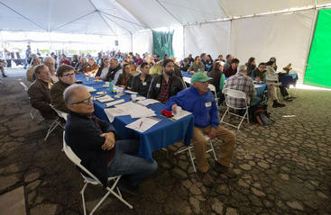 People sit in a large tent at UC Riverside's Citrus Day for the Industry