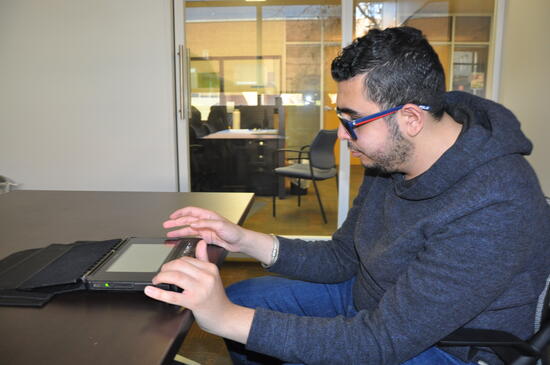 Student using Braille tablet