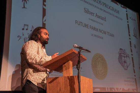 team member accepts award