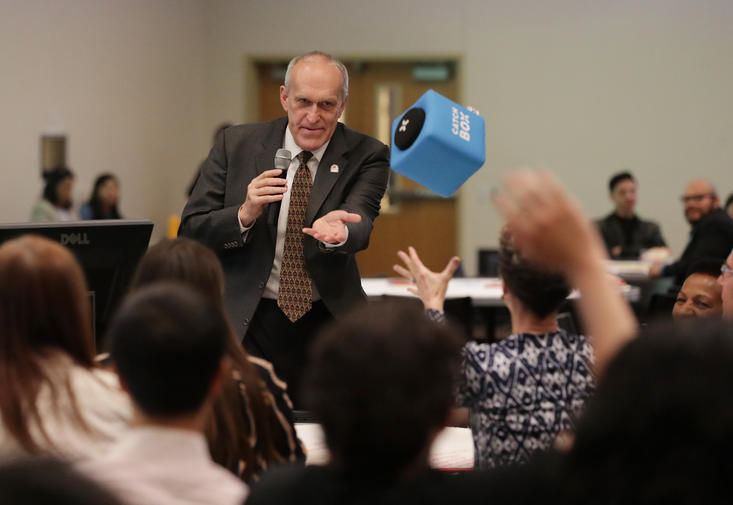 Chancellor Kim Wilcox tosses catch box to town hall audience.